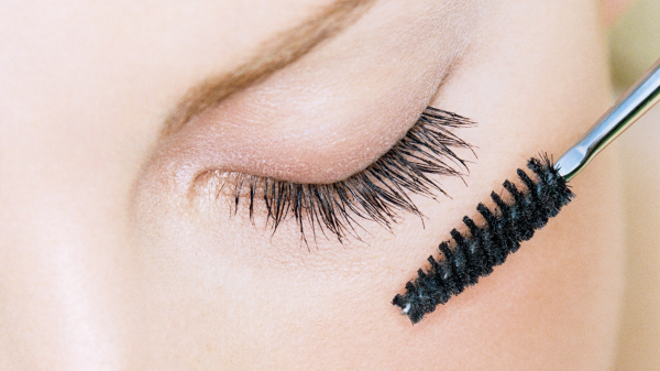 Young Woman Applying Mascara to Her Eyelashes Using TikTok's Mascara Trick